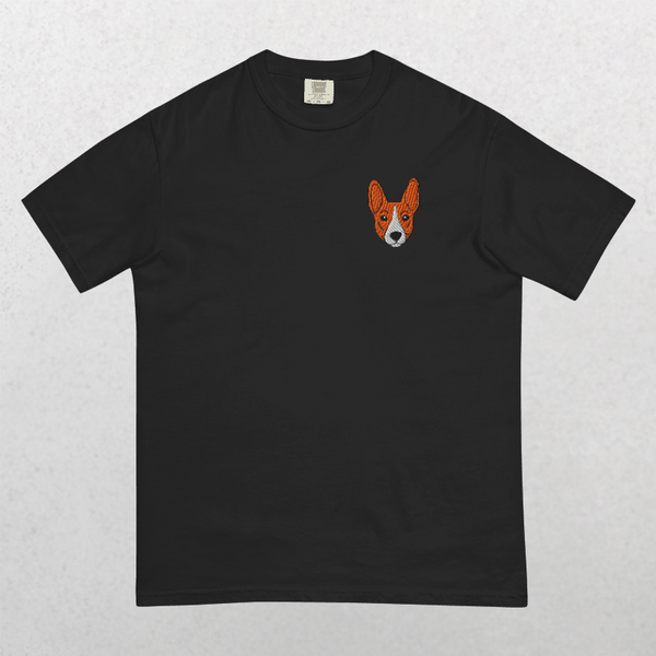 The Embroidered Pet Portrait Organic T-Shirt is a black tee featuring a small, orange, pointy-eared dog face embroidered on the left chest—a unique keepsake and thoughtful gift for pet lovers.