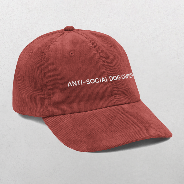 The Chord Vintage Cap - Anti Social Dog Owner is a maroon corduroy baseball hat with ANTI-SOCIAL DOG OWNER embroidered in white, shown on a light gray background. This funny slogan pet cap makes a perfect gift.
