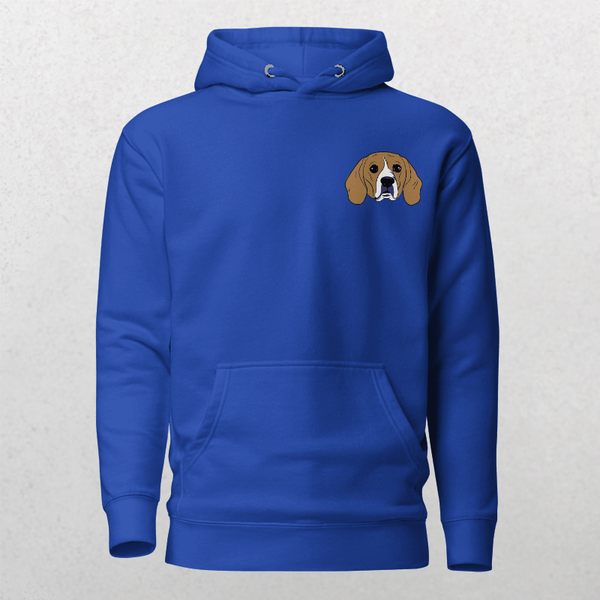 The Embroidered Custom Pet Hoodie in royal blue features a small, embroidered brown and white dog’s face on the left chest—displayed on a light textured background—making it an ideal cozy keepsake for any animal lover.