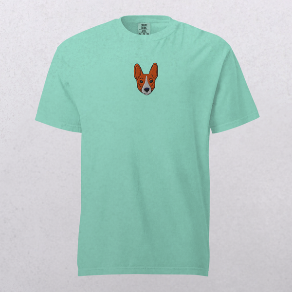 The Embroidered Pet Portrait Organic T-Shirt in light teal features a small embroidered cartoon dog face on the upper chest, making it a unique pet keepsake or a fun, casual wardrobe addition.
