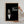 A person hangs The Dogfather Pet Portrait—a framed poster with a dog in a tuxedo and red rose, styled like The Godfather logo. Ideal as a pet lover gift or custom canvas for fans of personalized dog portraits.