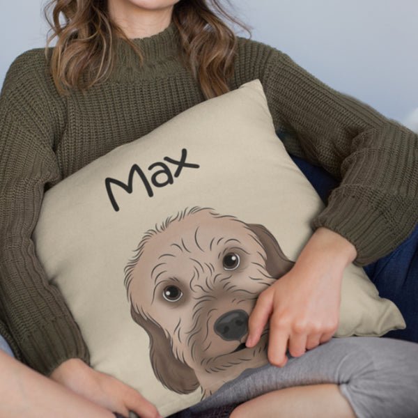 A person in a green sweater holds a Custom Cartoon Pet Cushion with an illustrated dog’s face and the name Max above it. This cozy keepsake is the perfect gift for pet lovers. The person’s face is not visible.
