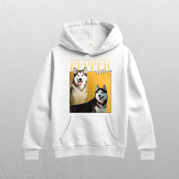 The Personalised Homage Hoodie | Gold is a white unisex hoodie featuring an illustration of two huskies, “PEPPER” and “WILSON”, on a yellow background, crafted from premium quality fleece for extra comfort.